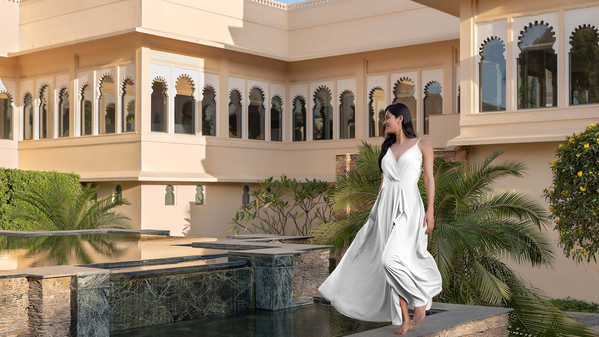 Garden and poolside area at Trident Udaipur, a 5 star hotel in Udaipur surrounded by lush green landscapes.