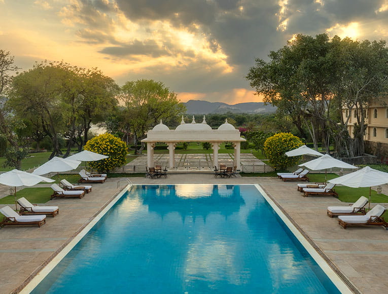 Outdoor pool view at Trident Udaipur, a 5 star hotel in Udaipur with scenic spaces for relaxation.